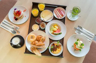 a table with plates of breakfast foods and drinks at Crowne Plaza Utrecht - Central Station by IHG in Utrecht