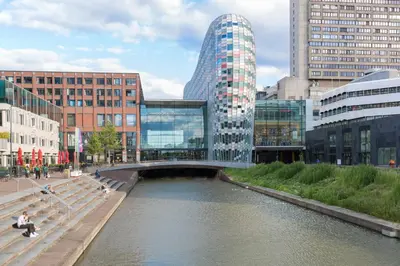 a bridge over a river in a city with buildings at Crowne Plaza Utrecht - Central Station by IHG in Utrecht
