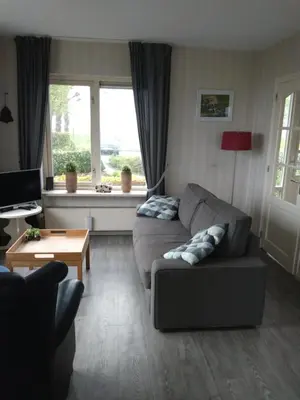 a living room with a couch and a table at Accommodatie op boerderij Buitenlust in Weesp