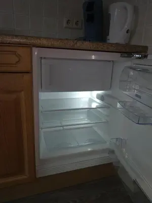 an empty refrigerator with its door open in a kitchen at Accommodatie op boerderij Buitenlust in Weesp