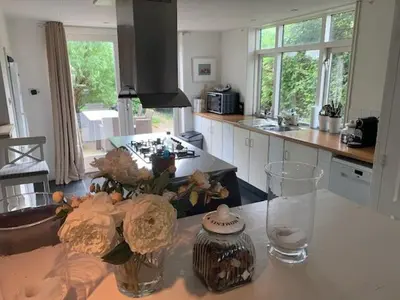 a kitchen with a counter with vases on a table at Holiday home at the water, fire place, boat and SUP rent, near Amsterdam in Aalsmeer