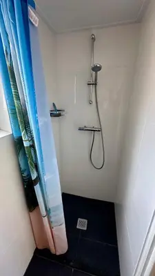 a shower in a bathroom with a shower curtain at Strandhuis Everts in Egmond aan Zee