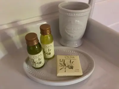 two bottles of olive oil on a plate with a cup at Bed & Breakfast Zevenhuizen in Zevenhuizen