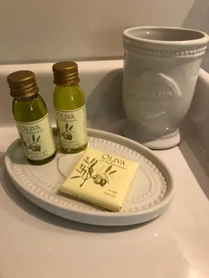 two bottles of honey and a plate with a book at Bed & Breakfast Zevenhuizen in Zevenhuizen