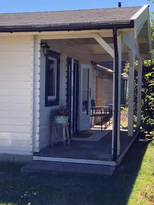 awning over a porch of a house with a table at Bed & Breakfast Zevenhuizen in Zevenhuizen