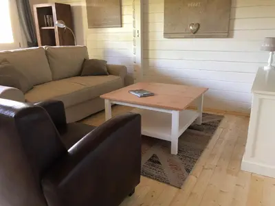 a living room with a couch and a coffee table at Bed & Breakfast Zevenhuizen in Zevenhuizen
