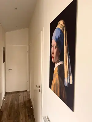 a painting of a woman with a on a wall at Exclusieve vakantievilla ***** Markermeer in Bovenkarspel