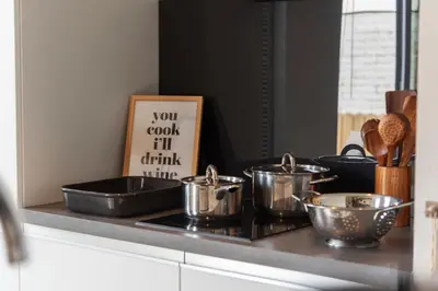 a kitchen counter with pots and pans on a stove at Oasis Studio- Free Parking in Zandvoort