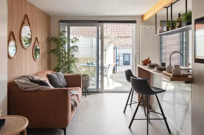 a living room with a couch and a kitchen at Oasis Studio- Free Parking in Zandvoort