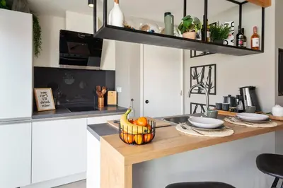 a kitchen with a counter with a bowl of fruit on it at Oasis Studio- Free Parking in Zandvoort