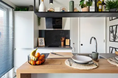 a kitchen with a wooden table with a bowl of fruit at Oasis Studio- Free Parking in Zandvoort