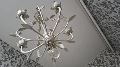 a metal chandelier with flowers on a ceiling at Fleurdelis in Lisse