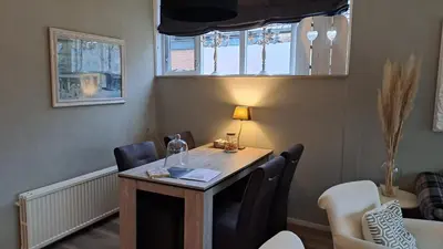 a room with a table and chairs and a window at Fleurdelis in Lisse