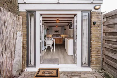 an open door leading to a kitchen and dining room at De Jutter - Zandvoort Free Parking in Zandvoort
