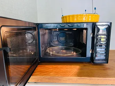 a microwave oven with its door open on a counter at Tulpenhoek in Akersloot