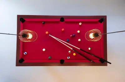a red clock with balls on it on a wall at Tulpenhoek in Akersloot
