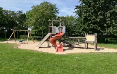 a playground with a red slide in a park at Rekerlanden 267 in Warmenhuizen