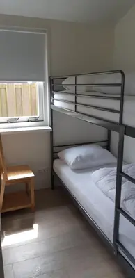 a bedroom with two bunk beds and a window at Rekerlanden 267 in Warmenhuizen