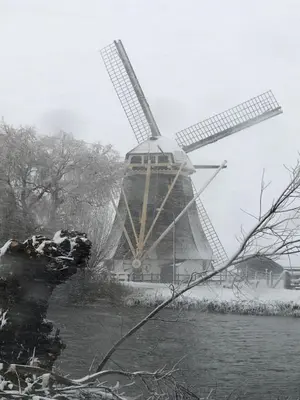 a windmill in the snow with at Mondriaanmolen, a real Windmill close to Amsterdam in Abcoude