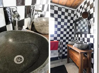 a bathroom with a sink and a bathroom with black and white tiles at Mondriaanmolen, a real Windmill close to Amsterdam in Abcoude