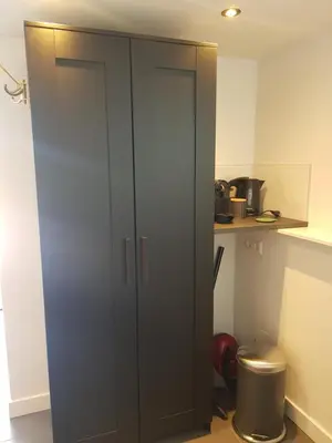 a black cabinet in a kitchen with a trash can at Mara's Place in Zandvoort