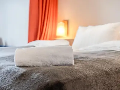 a white towel sitting on top of a bed at DFDS Ferry - Amsterdam to Newcastle in IJmuiden