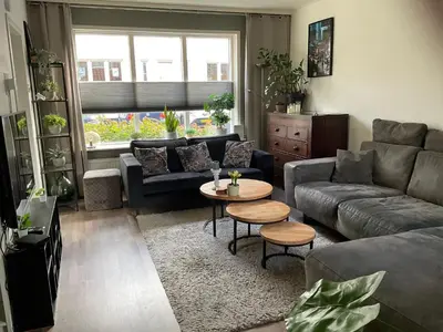 a living room with a couch and a table at Beemster Experience in Middenbeemster