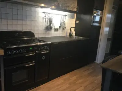 a kitchen with a stove and a sink at Beemster Experience in Middenbeemster