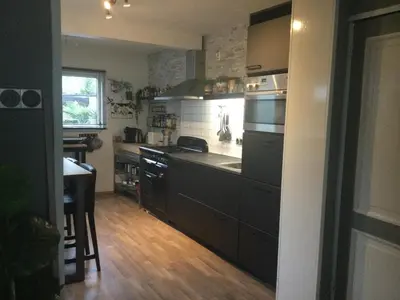 a kitchen with a sink and a stove top oven at Beemster Experience in Middenbeemster