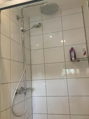 a shower with a glass door in a bathroom at Beemster Experience in Middenbeemster