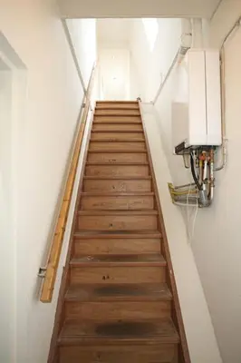 a staircase in a room with wooden floors and a light at Appartementen Purmerend B in Purmerend