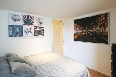 a bedroom with a bed and a picture on the wall at Appartementen Purmerend B in Purmerend