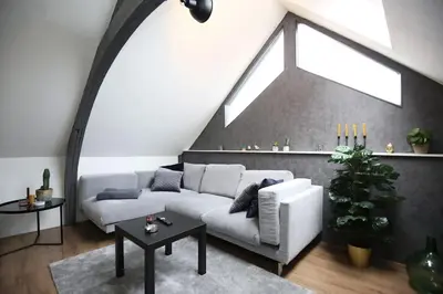 a living room with a white couch and a window at Appartementen Purmerend B in Purmerend
