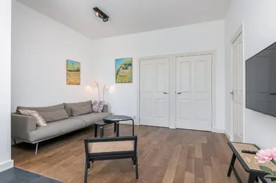 a living room with a couch and a table at Charming Apartments in Alkmaar