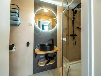 a bathroom with a sink and a shower at Hof van Schoorl in Schoorldam