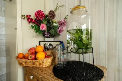 a table with a basket of fruit and a jar of dirt at Hof van Schoorl in Schoorldam