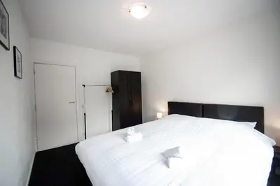 a bedroom with a large white bed with two pillows at Zandvoort North Spacious 2 bedroom apartment in Zandvoort