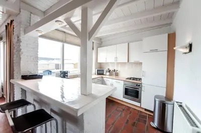 a kitchen with white appliances and a large window at Zandvoort North Spacious 2 bedroom apartment in Zandvoort