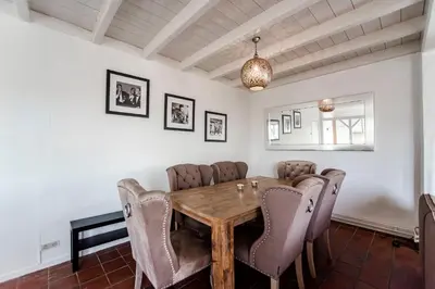 a dining room with a wooden table and chairs at Zandvoort North Spacious 2 bedroom apartment in Zandvoort