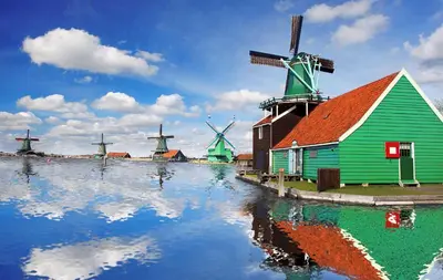 a group of windmills and a barn and a house at Valerius Boutique Hotel in Wormer