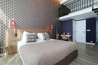 a bedroom with a large bed in a room at Valerius Boutique Hotel in Wormer