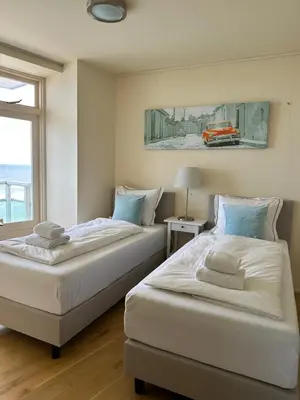 two beds sitting next to each other in a bedroom at The wave in Zandvoort
