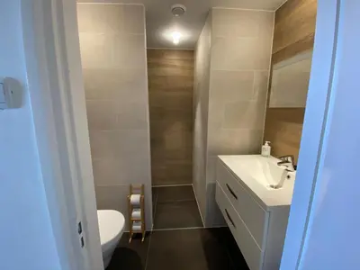 a bathroom with a toilet and a sink at The wave in Zandvoort