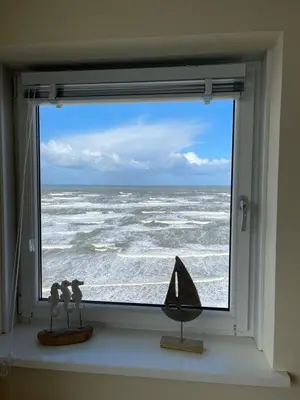 a window with a view of the ocean at The wave in Zandvoort