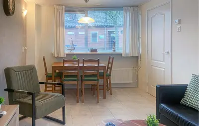 a kitchen and dining room with a table and chairs at Pet Friendly Home In Egmond Aan Zee in Egmond aan Zee