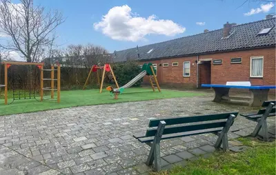a park with a playground with a bench and a table at Pet Friendly Home In Egmond Aan Zee in Egmond aan Zee