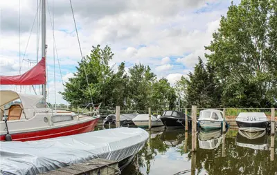 a group of boats are docked at a dock at Huis Nr 2 in Woubrugge