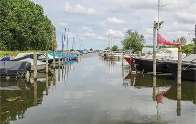 a group of boats docked in a marina at Huis Nr 5 in Woubrugge