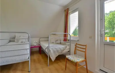 a bedroom with two bunk beds and a chair at Horsterhuis in Zeewolde