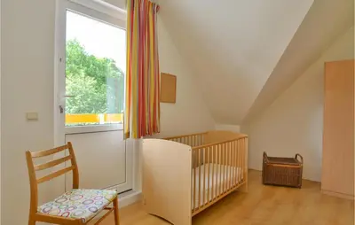 a baby room with a crib and a window at Horsterhuis in Zeewolde